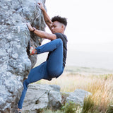 Adventurer climbing rocks wearing Trailhead mountain pants